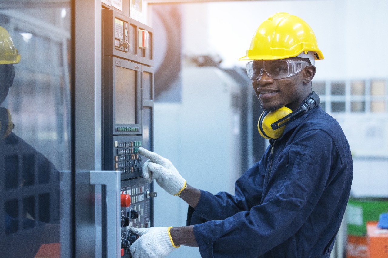 Black-Man-Working-at-Programmable-Machine