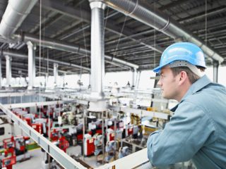 Man Looking Over Manufacturing Facility
