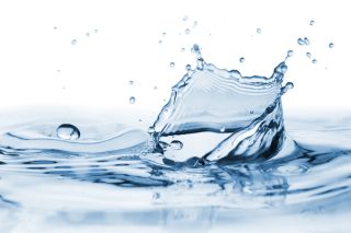 Clear, beautiful splash with drops on the water surfaceStock Photography: iStock-648721172.jpg